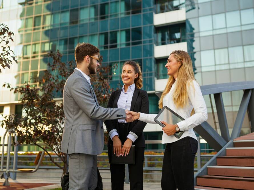 Group of business man and woman team at office shaking hands outdoors